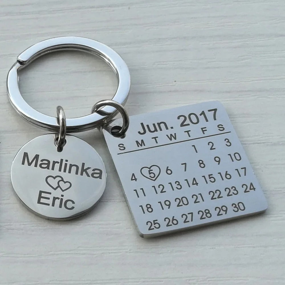 Keychain with the month's calendar and the date marked with a heart, and a tag with two names